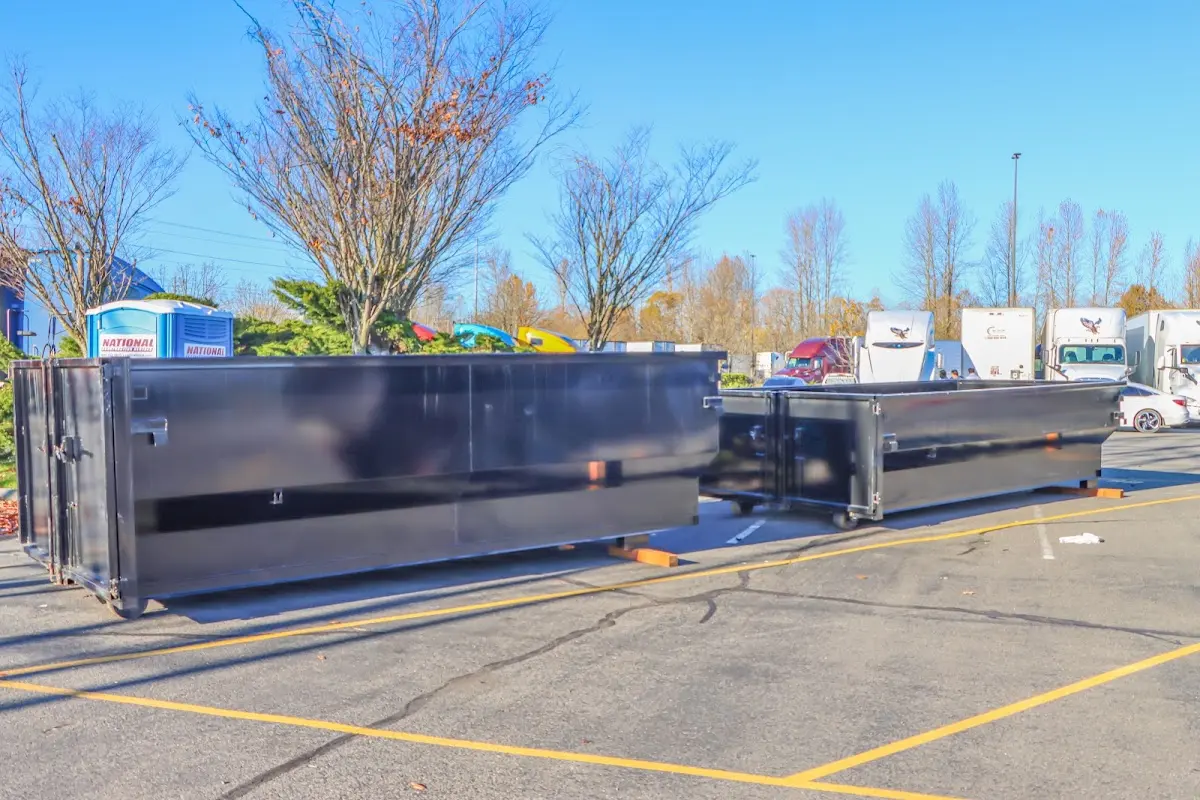 Professional dumpster rental service with roll-off container on residential driveway in Gering